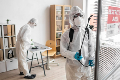 Two workers in full protective suits