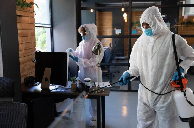 Pest exterminators fumigating an office space.