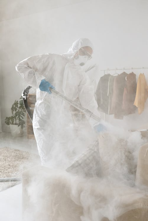 Image of an exterminator fumigating a room.